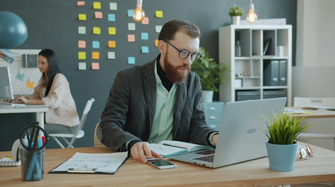 man working on laptop in modern office